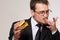 Hungry businessman eating hamburger