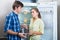 Hungry couple near empty fridge