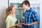 Hungry family standing near empty fridge