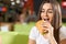 Hungry female biting croissant in cafe