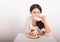 Hungry girl eating small gingerbread house