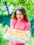 Hungry girl pizza box nature background, summer picnic ideas concept