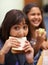 Hungry girl, portrait and student eating sandwich in classroom at school for meal, break or snack time. Young kid or