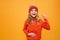 Hungry Happy Young girl in sweater and hat holding tummy