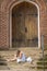 A Hungry Homeless Abandoned Runaway Child Looks For Food And Shelter In Front Of A Church