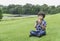 Hungry kid boy eating homemade bread sandwiches with mixed vegetables, Child siting on green grass eating his snack picnic in the