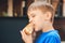 Hungry kid eating a burger at outdoors cafe