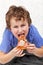 Hungry kid eating pizza