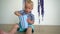 Hungry little boy eating popcorn from paper box on wooden floor. Gimbal motion