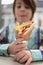 Hungry little boy holding gyros sandwich wrapped in pita bread. White kid enjoying traditional Greek fast food with grilled meat,