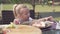 Hungry little girl eating pizza in a cafe on the street on a hot summer day