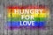 Hungry for love and LGBT flag painted on background texture gray