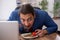 Hungry male employee eating buckwheat during break