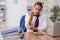 Hungry male employee eating buckwheat during break