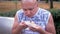 Hungry Male Resting on a Bench, Eating Shawarma Bread Outdoors in Park on Street