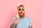 Hungry man with beard and tattoos eats a big icecream