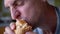 Hungry man takes a bite of delicious and crispy shawarma close-up. Slow motion.