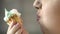 Hungry overweight female eating creamy dessert with appetite, junk food, obesity