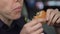 Hungry policewoman eating burger greedily, having lack of time for dinner, duty
