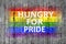 Hungry for PRIDE and LGBT flag painted on background texture gray