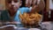 Hungry Teen Steals Potato Chips from Table in a Plate While No One Sees