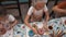 Hungry teenagers eating donuts with colorful glaze on culinary kitchen. Happy children in cook hat and apron eating