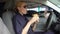 Hungry woman cop eating burger sitting in police car in parking lot, junk food