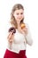 Hungry woman holding sweet muffin and donut