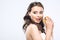 hungry young bride in wedding dress with burger in hands showing tongue and looking away