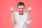 Hungry young man holding fork and knife on hand ready to eat, licking lips.