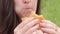 Hungry young woman eating a delicious burger
