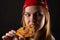 Hungry young woman eating pizza