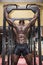 Hunky muscular black bodybuilder working out in