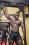 Hunky muscular black bodybuilder working out in