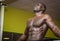 Hunky muscular black bodybuilder working out in gym