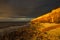 Hunstanton Cliffs at sunset with dark stormy sky