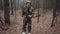 Hunter forest ranger dressed in a camouflage suit tells something to camera. Strange correspondent reporter with