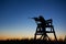 Hunter in lookout tower by dusk