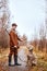 hunter male with strong dog of Weimaraner breed on early autumn landscape, in nature