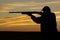 Hunter Shooting in Sunset