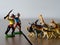 Hunters against wild animals. Miniature plastic figures. Soft focus effect.