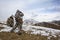 Hunters in the mountains in winter camouflage watching through binoculars