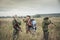 Hunters preparing for hunting in rural field in overcast day during hunting season