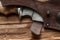 Hunting damascus steel knife handmade on a wooden background, close-up