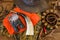 Hunting equipments on the old wooden background top view. Hunting belt, hat, camouflage, orange waistcoat, sleeves, deer antler,