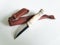 A hunting knife with a short blade and a bone handle with a leather case on a white background