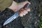 Hunting knife in a tight hand