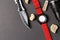 Hunting objects, folding hunting knife , red smartwatch and black flashlight on black background.