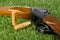 Hunting rifle and two cartridges on a green lawn