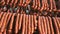 Hunting sausages close - up which is suspended on the shelves, dries in the storage room. Panorama of the sausage which
